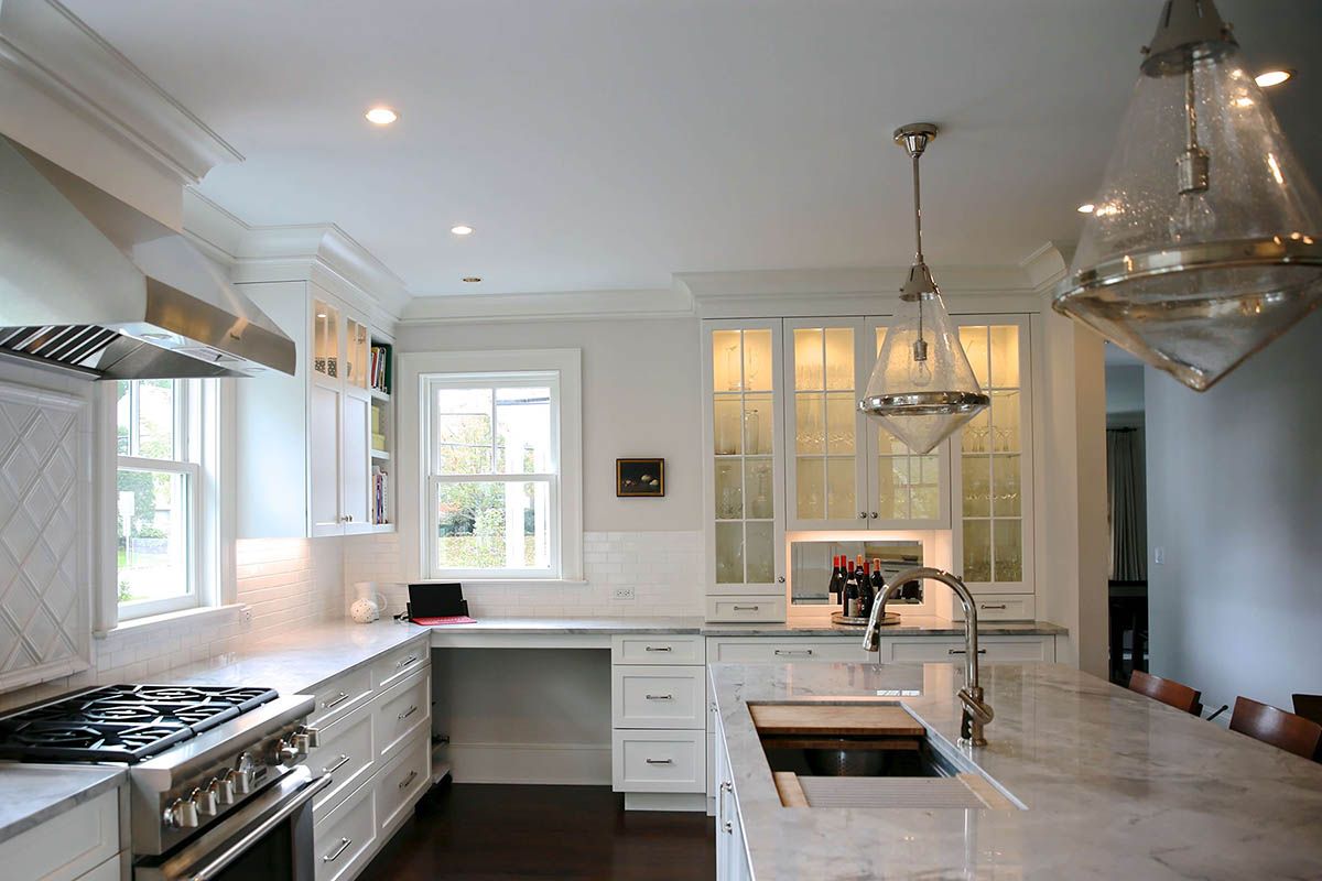Side View of Kitchen with White Cabinets and Glass Cabinet Doors